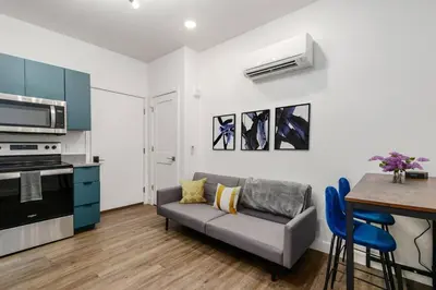 a living room with a couch and a table at Oasis with Pool Table! Stylish Stay, Pets Allowed! in Columbus