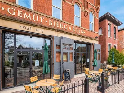 a restaurant with tables and chairs in front of a building at Oasis with Pool Table! Stylish Stay, Pets Allowed! in Columbus