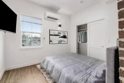 a white bedroom with a bed and a window at Oasis with Pool Table! Stylish Stay, Pets Allowed! in Columbus