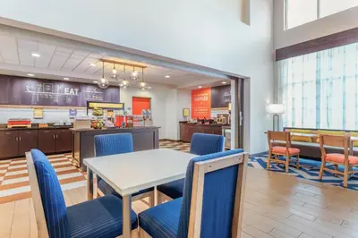 a dining room with a table and chairs at Hampton Inn and Suites Parkersburg Downtown in Parkersburg