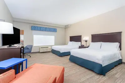 a hotel room with two beds and a flat screen tv at Hampton Inn and Suites Parkersburg Downtown in Parkersburg
