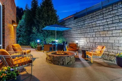 a patio with chairs and a table with an umbrella at Hampton Inn and Suites Parkersburg Downtown in Parkersburg