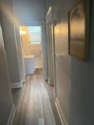 a hallway with a door to a room with a wooden floor at Walnut Hills Studio/ Private room in Cincinnati