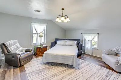 a bedroom with a bed and a couch and a chair at Greenwich Countryside Apartment with Shared Yard in Greenwich