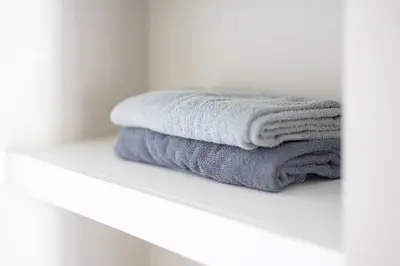 a stack of towels sitting on a shelf in a bathroom at Luxury Downtown Townhome Unit 14 in Cleveland
