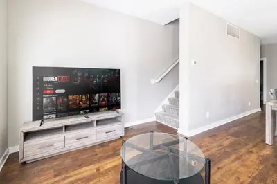 a living room with a large flat screen tv at Luxury Downtown Townhome Unit 14 in Cleveland