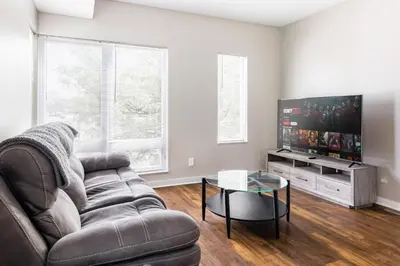 a living room with a couch and a flat screen tv at Luxury Downtown Townhome Unit 14 in Cleveland