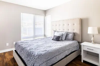 a bedroom with a large bed with a large window at Luxury Downtown Townhome Unit 14 in Cleveland