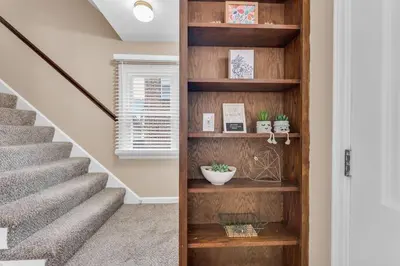 a staircase with wooden shelves in a house at Central Falls Hideaway in Cuyahoga Falls