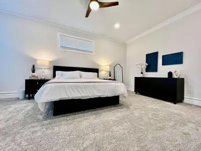 a white bedroom with a large bed and two dressers at NEW, big, beautiful, Executive Home Liberty Twp in Middletown