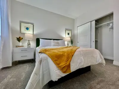 a bedroom with a bed with a yellow blanket on it at NEW, big, beautiful, Executive Home Liberty Twp in Middletown