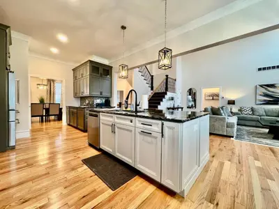 an open kitchen and living room with wooden floors at NEW, big, beautiful, Executive Home Liberty Twp in Middletown