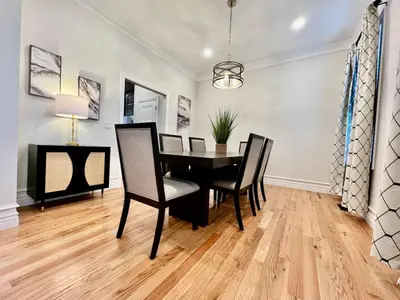 a dining room with a black table and chairs at NEW, big, beautiful, Executive Home Liberty Twp in Middletown