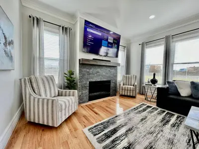 a living room with a fireplace and a flat screen tv at Luxury Home Incredible master suite Liberty Twp OH in Middletown