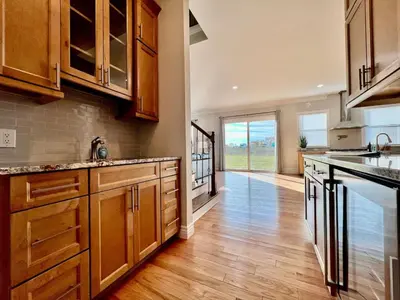 a kitchen with wooden cabinets and a wooden floor at Luxury Home Incredible master suite Liberty Twp OH in Middletown