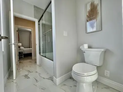 a white bathroom with a toilet and a shower at Luxury Home Incredible master suite Liberty Twp OH in Middletown