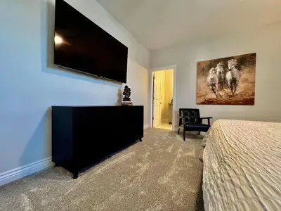a bedroom with a bed and a flat screen tv at Luxury Home Incredible master suite Liberty Twp OH in Middletown