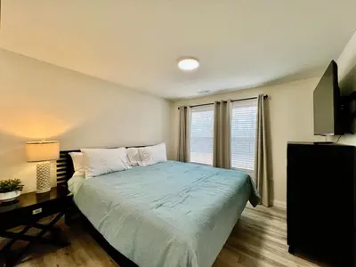 a bedroom with a bed and a desk and a television at Beautiful NEW Ranch Home with a large deck and games in Maud