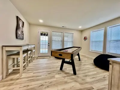 a living room with a pool table in it at Beautiful NEW Ranch Home with a large deck and games in Maud