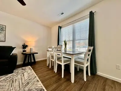 a dining room with a table and chairs and a window at Brand new, hidden Pearl of a home Batesville, IN in Batesville