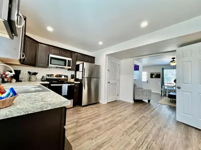a kitchen with a stainless steel refrigerator and a dining room at Pearl of a new construction home Batesville, IN in Batesville