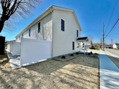 a white church with a large white garage door at Pearl of a new construction home Batesville, IN in Batesville