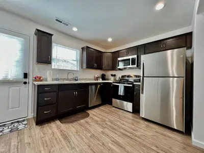 a kitchen with wooden cabinets and a stainless steel refrigerator at Pearl of a new construction home Batesville, IN in Batesville