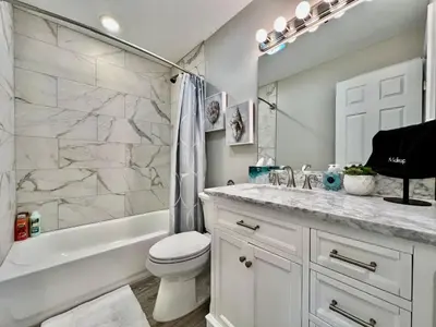 a bathroom with a toilet and a tub and a sink at New remodel exquisite master suite Trenton, Ohio in Trenton