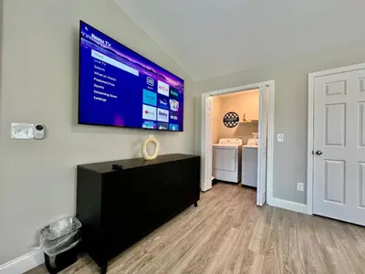 a living room with a large flat screen tv on the wall at New remodel exquisite master suite Trenton, Ohio in Trenton