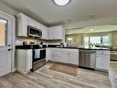 a kitchen with white cabinets and black appliances at New remodel exquisite master suite Trenton, Ohio in Trenton