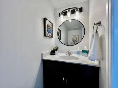 a bathroom with a sink and a mirror at Pearl of a home, central Batesville, IN -New build in Batesville