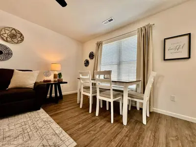 a living room with a table and chairs and a couch at Pearl of a home, central Batesville, IN -New build in Batesville
