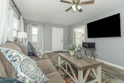 a living room with a couch and a flat screen tv at Furnished Ranch Home with FREE washer and dryer in Middletown