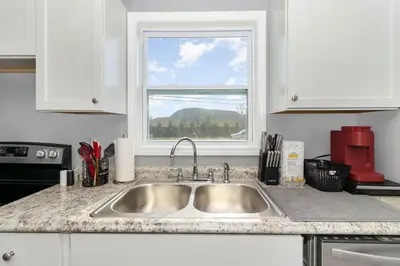 a kitchen counter with a sink and a window at Furnished Ranch Home with FREE washer and dryer in Middletown