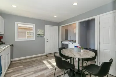 a kitchen and dining room with a table and chairs at Furnished Ranch Home with FREE washer and dryer in Middletown