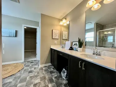 a bathroom with a sink and a large mirror at Brand new Executive home in Liberty Twp, Ohio in Maustown