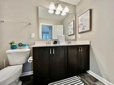 a bathroom with a sink and a toilet and a mirror at Brand new Executive home in Liberty Twp, Ohio in Maustown