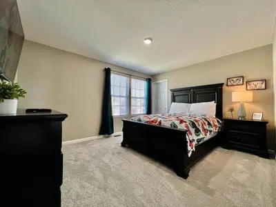 a large bedroom with a bed and a window at Brand new Executive home in Liberty Twp, Ohio in Maustown