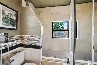 a bathroom with a tub and a sink and a shower at Part of Mini-Mansion, private, 3 story Lake Erie views in Luna Pier
