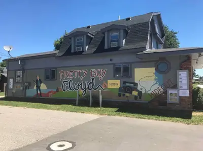 a building with a mural on the side of it at Actual Pretty Boy Floyd's Hideout - Lake Erie, MI in Luna Pier