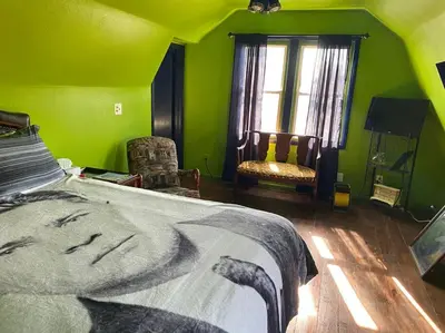 a bedroom with a bed with a picture of a woman at Actual Pretty Boy Floyd's Hideout - Lake Erie, MI in Luna Pier