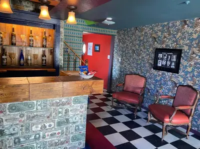 a bar with two chairs and a counter in a room at Actual Pretty Boy Floyd's Hideout - Lake Erie, MI in Luna Pier