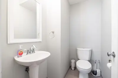 a white bathroom with a sink and a toilet at Luxury Downtown Townhome Unit 7 in Cleveland