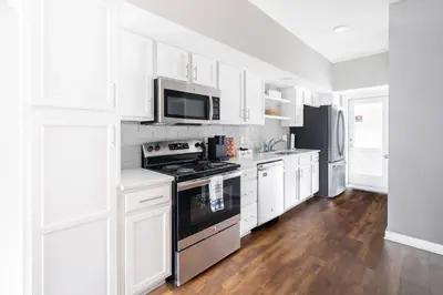 a kitchen with white cabinets and a stove top oven at Luxury Downtown Townhome Unit 7 in Cleveland