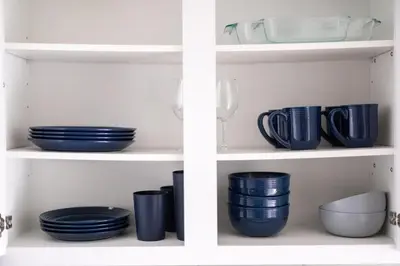 two shelves filled with blue plates and bowls at Luxury Downtown Townhome Unit 15 in Cleveland