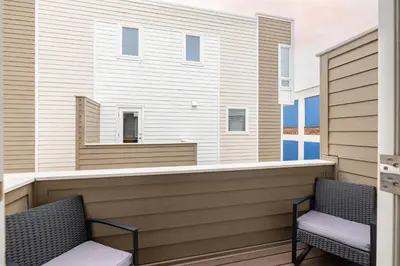 two chairs on the balcony of a house at Luxury Downtown Townhome Unit 15 in Cleveland