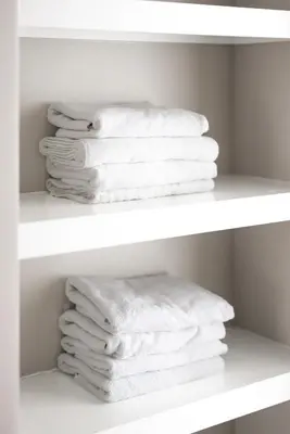 a stack of white towels on a shelf at Luxury Downtown Townhome Unit 15 in Cleveland