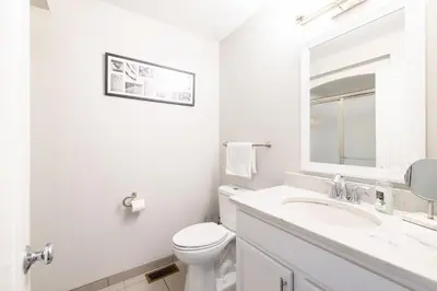 a white bathroom with a sink and a toilet at Luxury Downtown Townhome Unit 15 in Cleveland