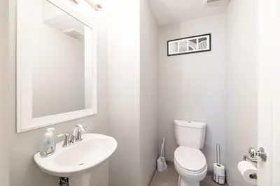 a white bathroom with a sink and a toilet at Luxury Downtown Townhome Unit 15 in Cleveland