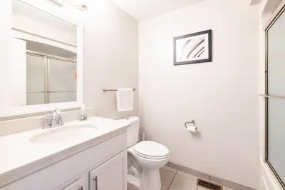 a white bathroom with a sink and a toilet at Luxury Downtown Townhome Unit 15 in Cleveland